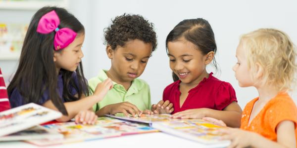 A group of children reading a book.