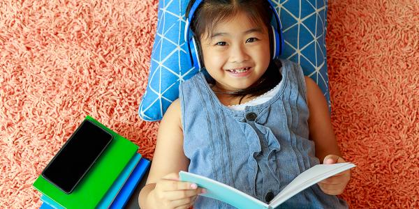 A young child reading a book.