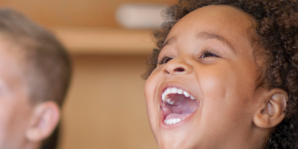 a child clapping and smiling