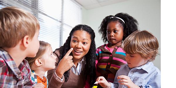 Teacher in a classroom with diverse group of preschoolers