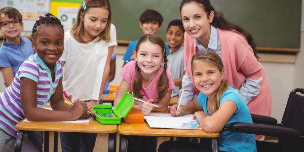 Teacher in a classroom with a group of early primary students