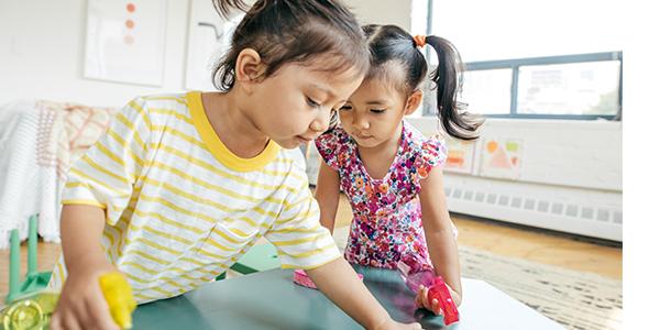 Two preschool girls playing in the classroom