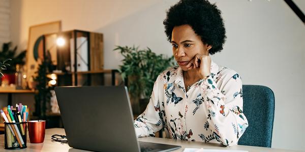 Woman at a computer staring at a screen