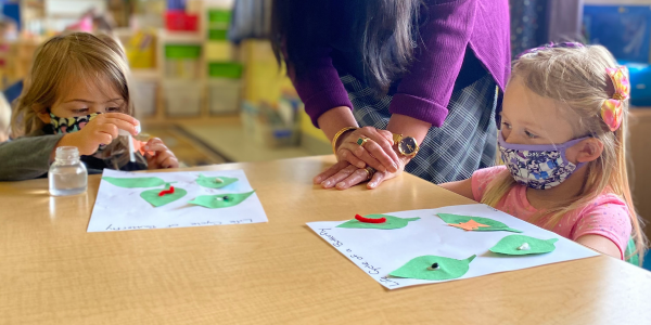 children doing nature based crafts with paper leaves