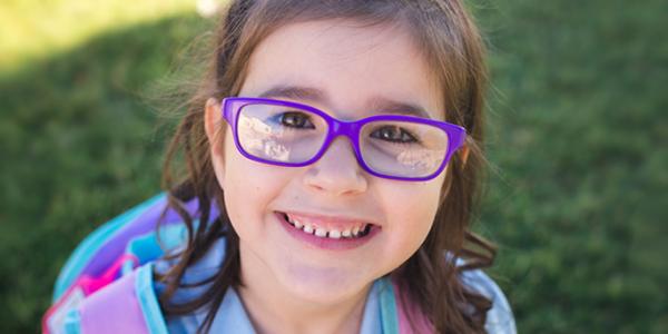 Girl in glasses wearing a bookbag