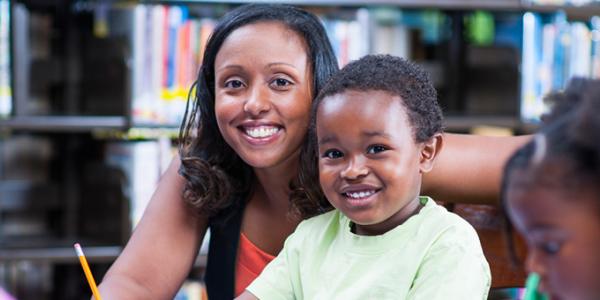 Teacher assisting child in the classroom