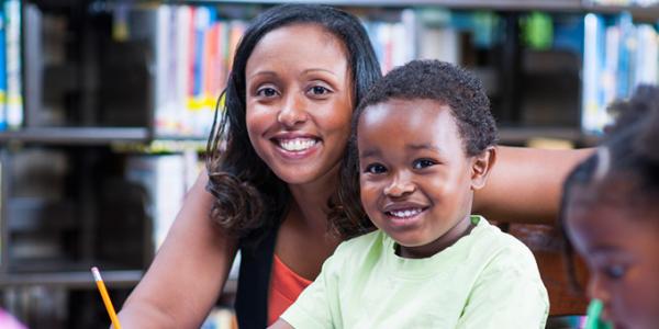 Educator with smiling with child