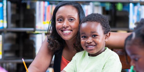 Educator with smiling child