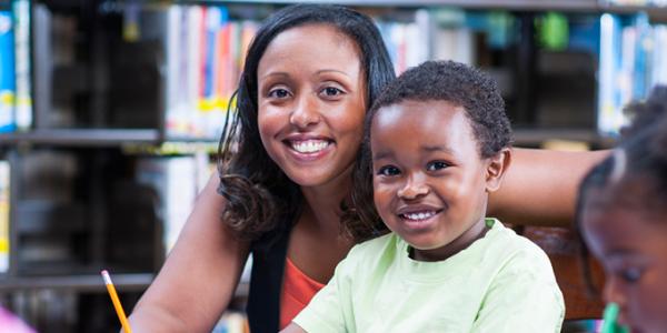 Educator with smiling child