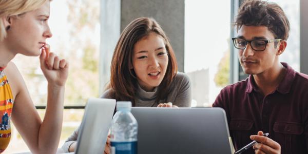 Seeking an Early Childhood Degree? College students gathered around a computer screen