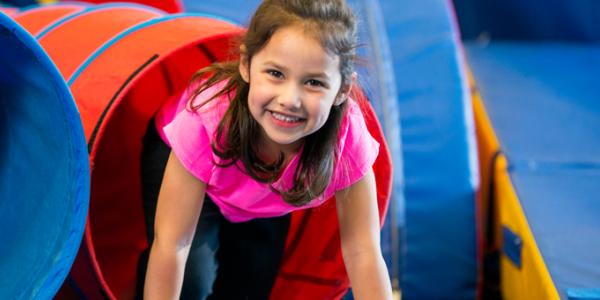 A child crawls through a tube