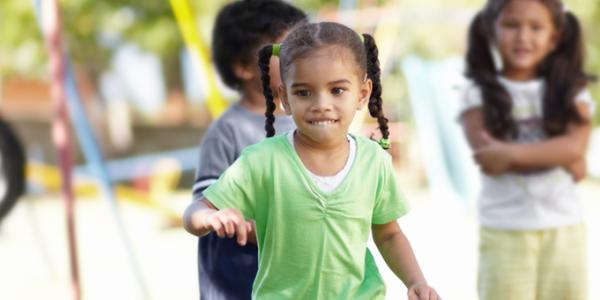 Little girl playing on a  playground