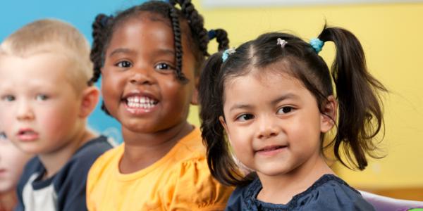 Group of five diverse children smiling