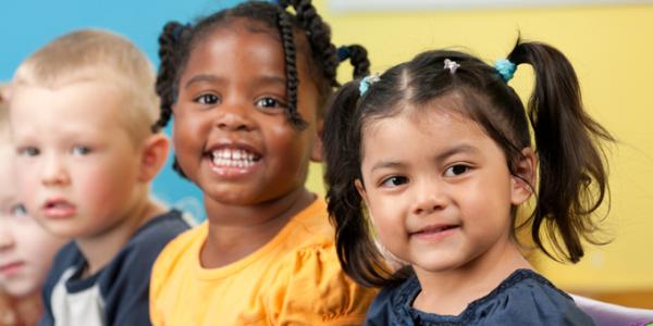 Children standing in a row and smiling