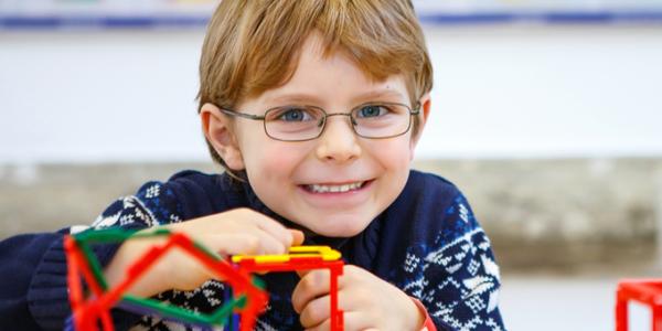 Boy building a structure with toys