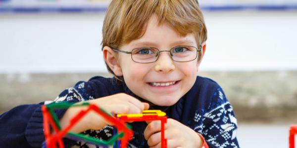 Young boy playing with plastic cubes