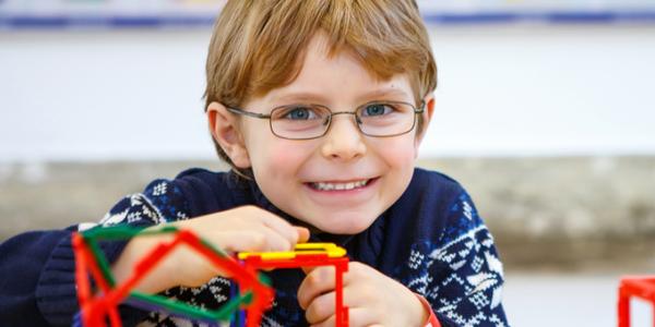 Young boy playing with plastic cubes