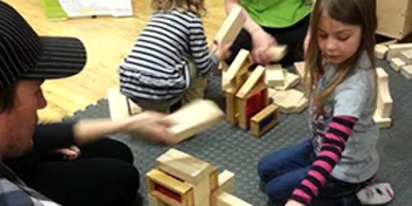 Young children playing with blocks in the classroom.