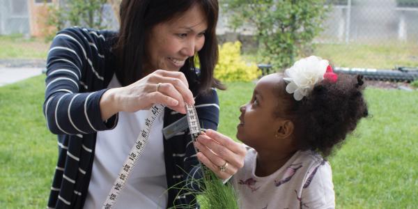 Teacher and student learning how to measure