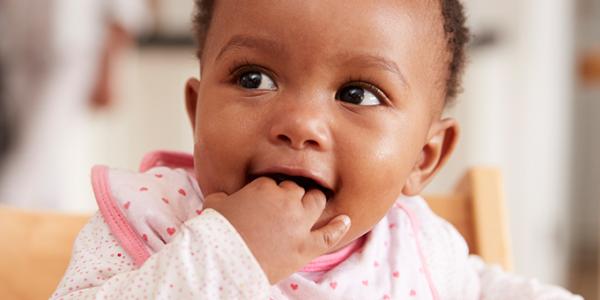 Baby with hand in her mouth,