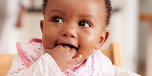 Toddler with hand in mouth