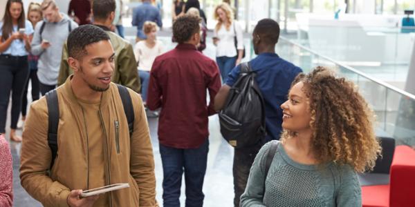 College students walking down a hallway