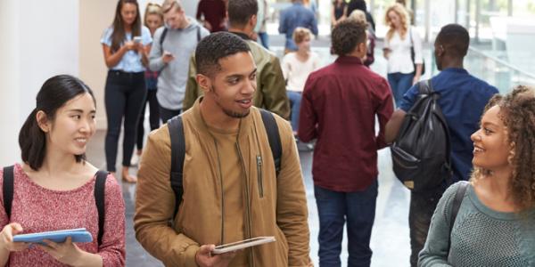 Young adults walking down a hall