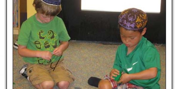 Two boys playing with blocks on floor