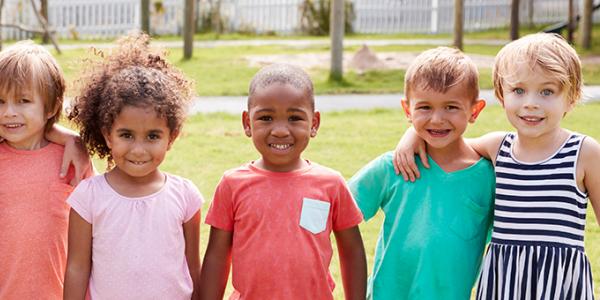 Young children outside holding hands