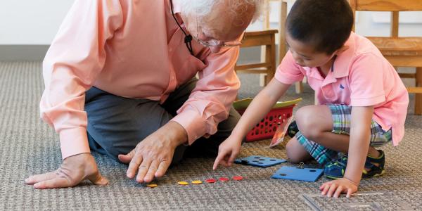 Teacher playing math game with child