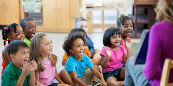 Preschool class sitting in circle for story time 