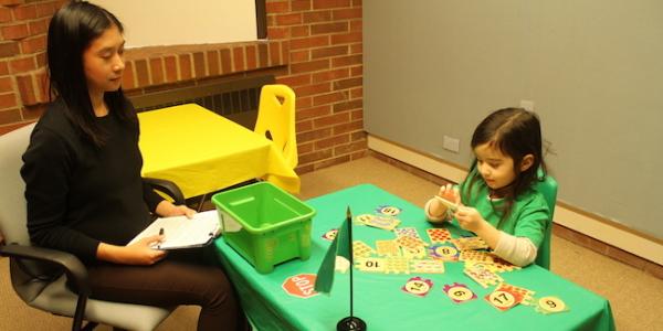 Teacher guiding student with STEM game