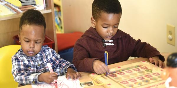 Two boys working at a table