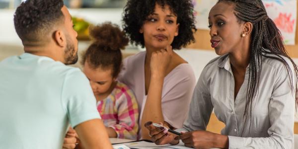 A teacher meets with a family