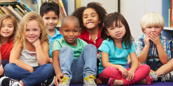 A diverse group of young children looking forward to a read aloud