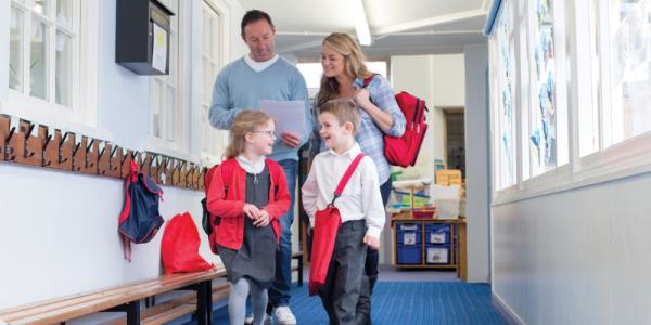 Family walking down school hallway.