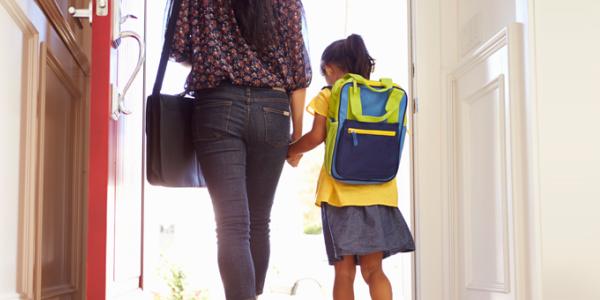 Mom and daughter walking into school holding hands