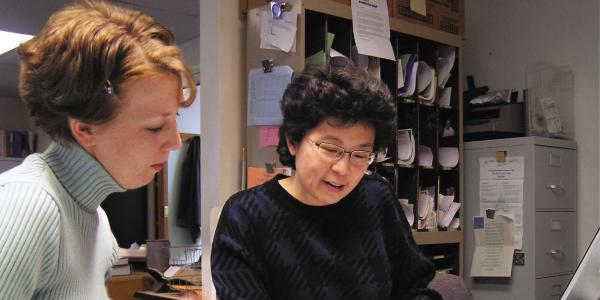 Two women looking at paperwork together