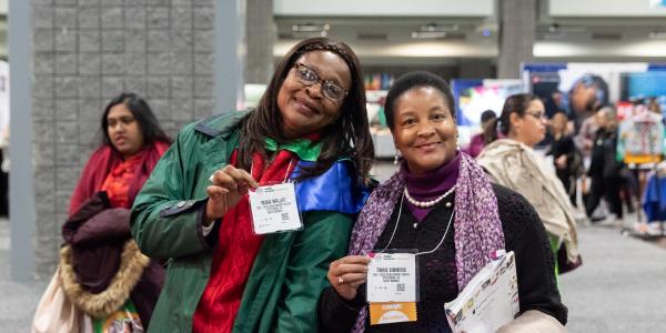 Two women pose for a picture at NAEYC's Annual Conference