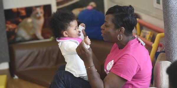 Black early childhood educator with young child