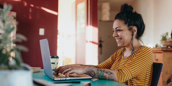 woman on a laptop smiling