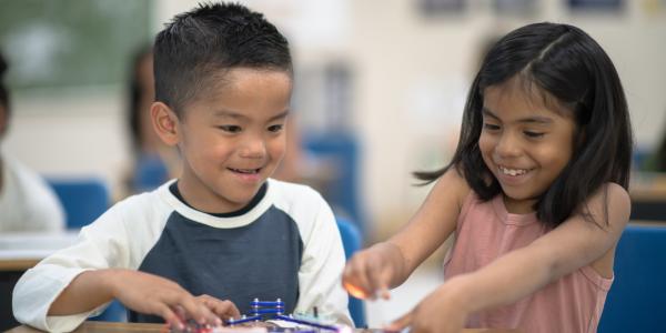 Two students working on a project in a classroom