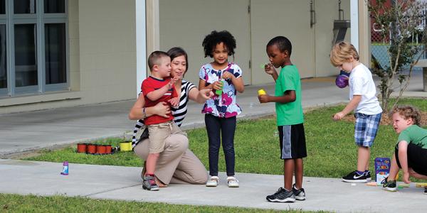 teacher with students on playground