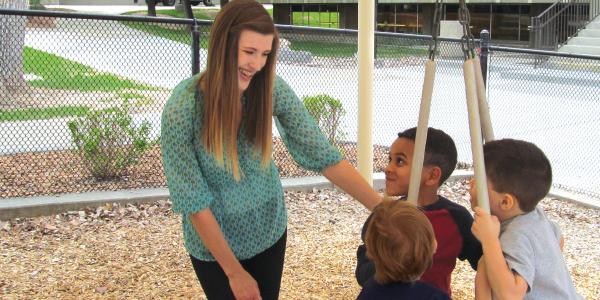 teacher with students on playground