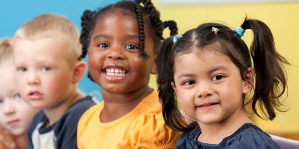 A diverse group of young children smiling