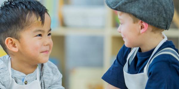 Two boys smiling in class