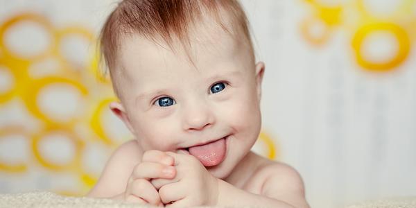 Infant sticking tongue out at camera