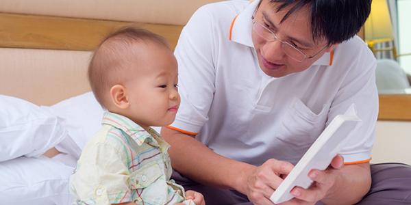 Father reading to baby