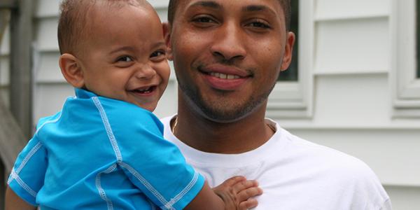 Father and baby boy smiling