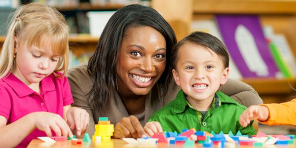 Teacher in the classroom with young children.